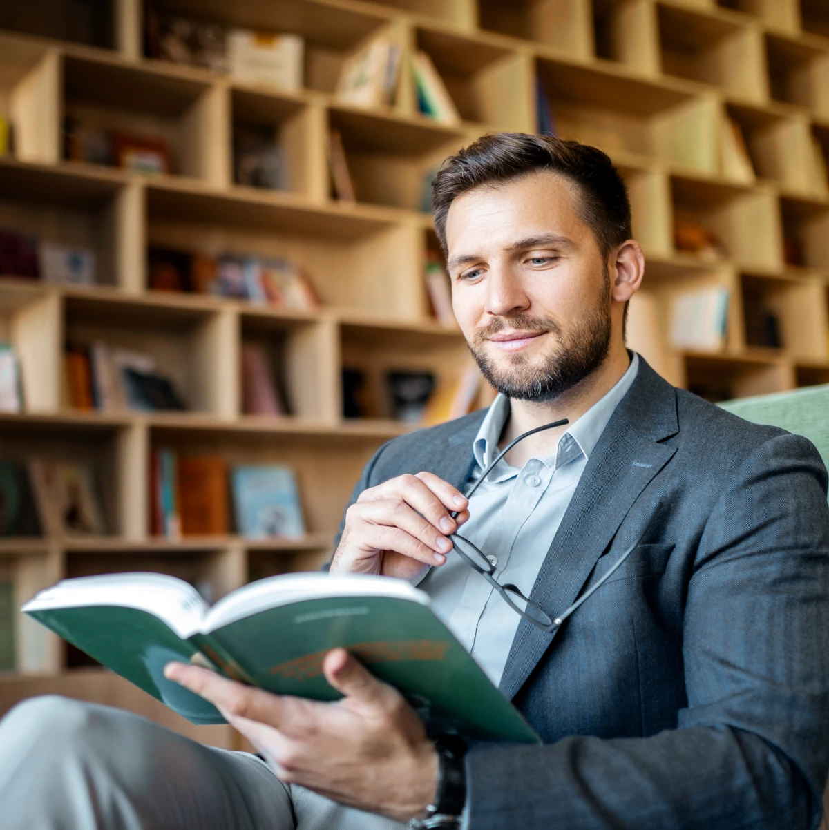 Man reading book in library