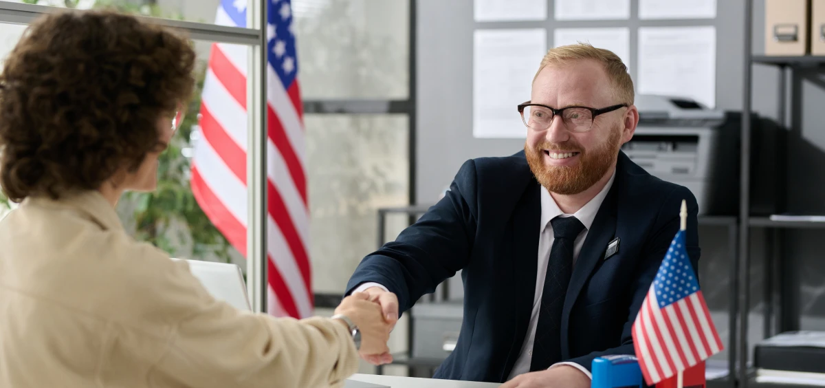 Professional meeting with handshake and flags