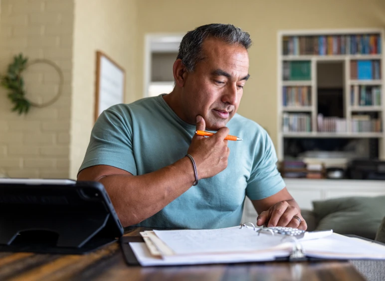 Man studying with tablet and notebook